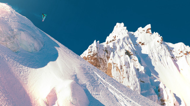 Snowboarder jumping mountain blue sky free wallpaper for desktop - medium preview image