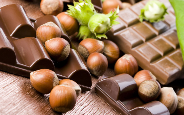 Chocolates nuts wooden table green free wallpaper for desktop - medium preview image