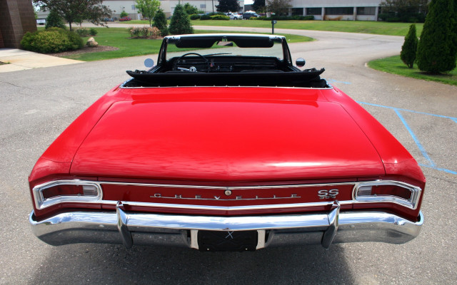 Red car parked next to free wallpaper for desktop - medium preview image