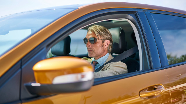 Man suit sunglasses driving yellow free wallpaper for desktop - medium preview image