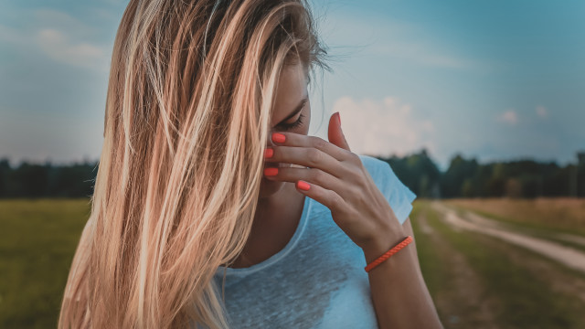 Blonde woman hands face sky free wallpaper for desktop - medium preview image