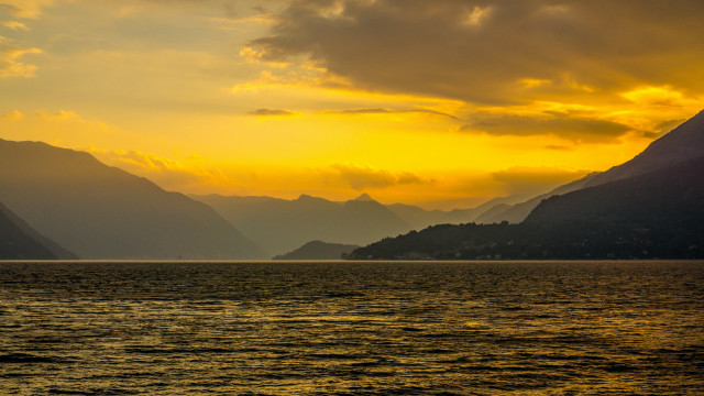 Sunset mountains boat water yellow free wallpaper for desktop - medium preview image