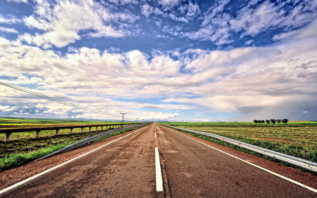Cloudy sky road grass field free wallpaper for desktop - medium preview image