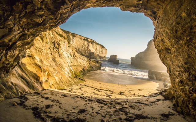 Cave ocean beach person sand free wallpaper for desktop - medium preview image