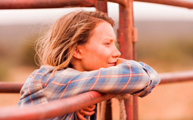 Woman leaning fence blurry background free wallpaper for desktop - medium preview image