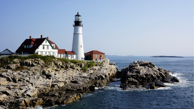 Lighthouse rocky cliff ocean boat free wallpaper for desktop - medium preview image