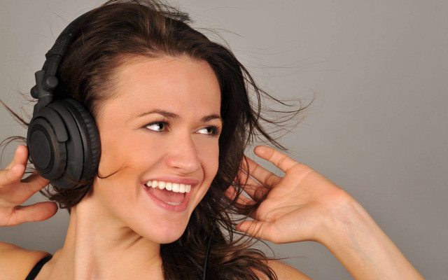 Woman headphones smiling blowing wind free wallpaper for desktop - medium preview image