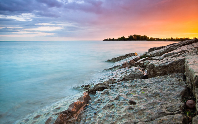Rocky shore sunset island city free wallpaper for desktop - medium preview image