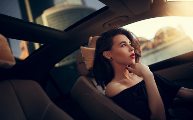 Woman sitting car sky buildings free wallpaper for desktop - medium preview image