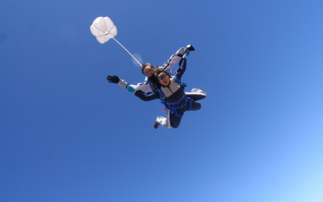 Woman parachute helmet blue sky free wallpaper for desktop - medium preview image