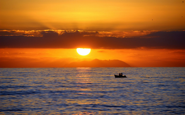 Sunset boat water mountain clouds free wallpaper for desktop - medium preview image