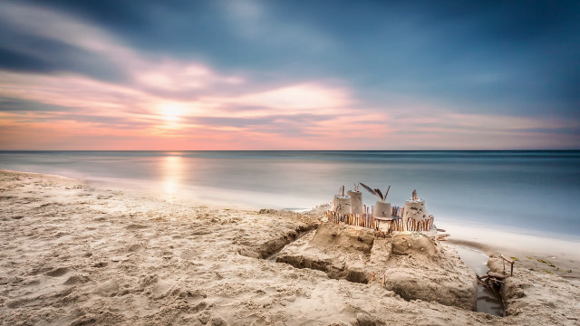 Sandcastle beach sunset water landscape free wallpaper for desktop - medium preview image