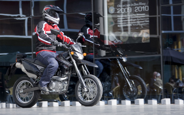 Man riding motorcycle street tall free wallpaper for desktop - medium preview image