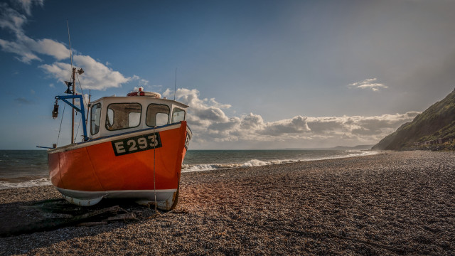Boat beach ocean cloudy mountain free wallpaper for desktop - medium preview image
