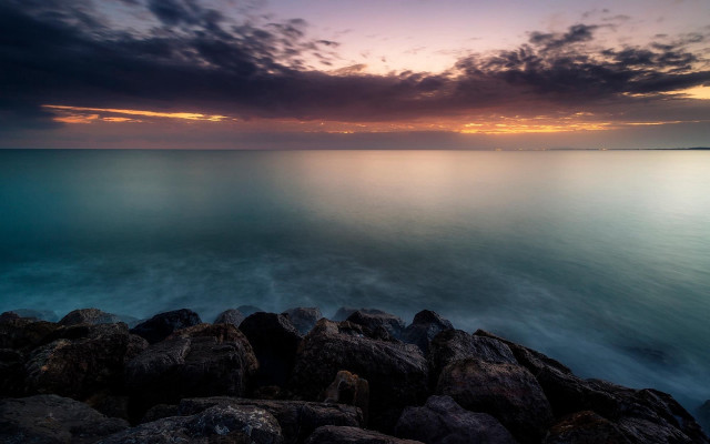 Rocky shore sunset water mountains free wallpaper for desktop - medium preview image