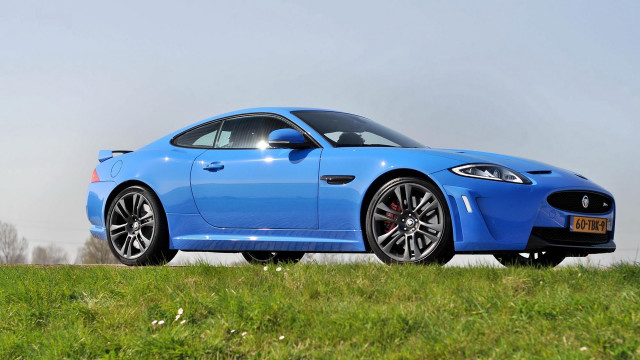 Blue sports car grassy hill free wallpaper for desktop - medium preview image