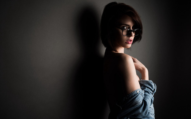 Woman glasses leaning wall portrait free wallpaper for desktop - medium preview image