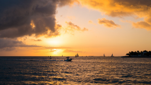 Boat sunset clouds island water free wallpaper for desktop - medium preview image