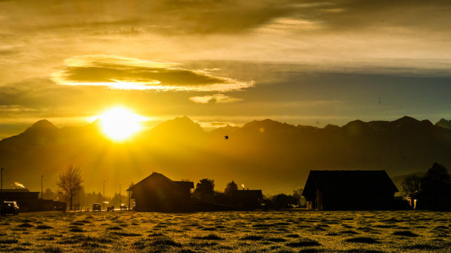 Sunset field houses mountains bird free wallpaper for desktop - medium preview image