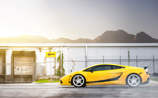 Yellow sports car building mountains free wallpaper for desktop - medium preview image