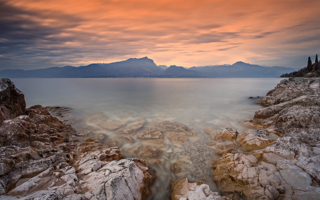Rocky shore mountains sunset ocean free wallpaper for desktop - medium preview image