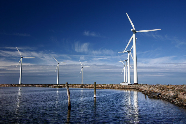 Wind turbines water rocks sky free wallpaper for desktop - medium preview image