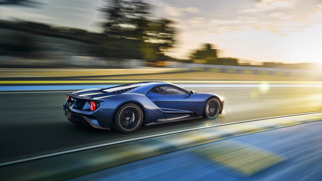Blue sports car sunset motion free wallpaper for desktop - medium preview image