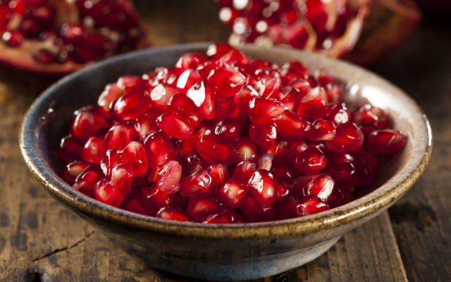 Pomegranate bowl wooden table closeup free wallpaper for desktop - medium preview image