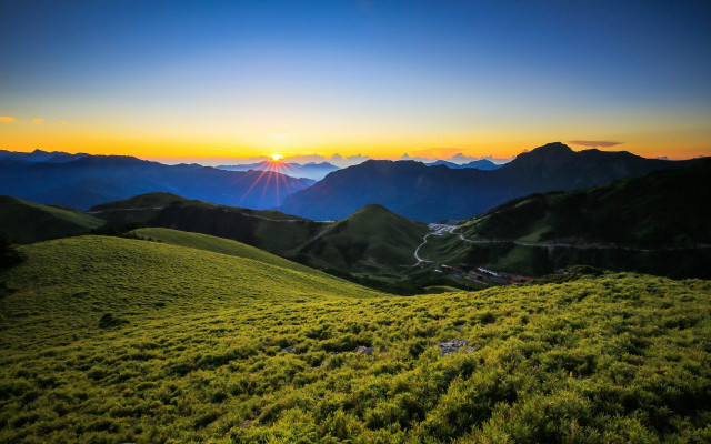 Grassy field mountains sunset trail free wallpaper for desktop - medium preview image