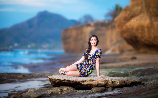 Woman rock ocean mountain beach free wallpaper for desktop - medium preview image