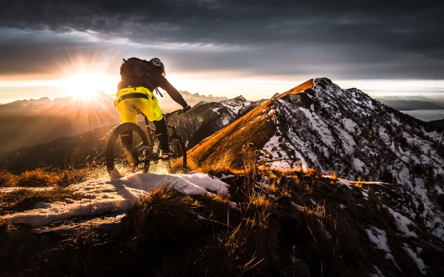 Man bike snow sunset mountains free wallpaper for desktop - medium preview image
