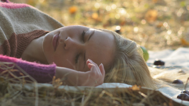 Woman lying in grass blurry free wallpaper for desktop - medium preview image