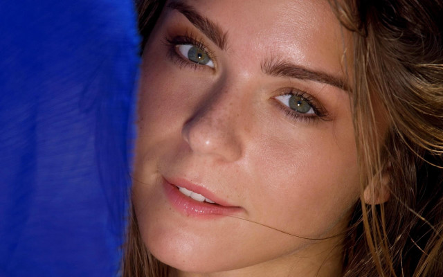 Woman blue umbrella serious face free wallpaper for desktop - medium preview image