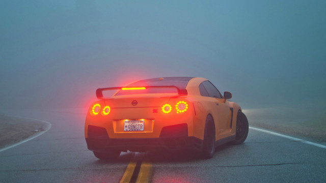 Yellow sports car foggy road free wallpaper for desktop - medium preview image