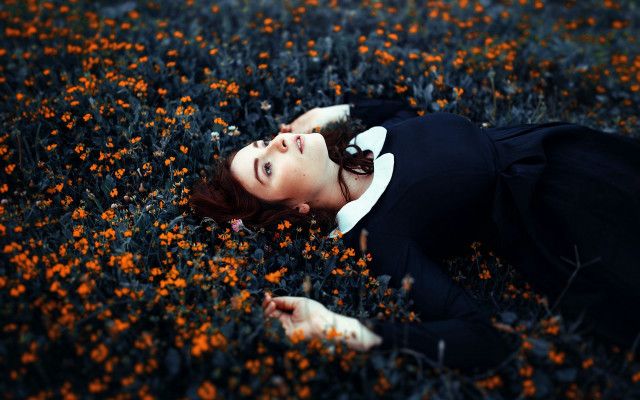 Woman laying flowers eyes closed free wallpaper for desktop - medium preview image