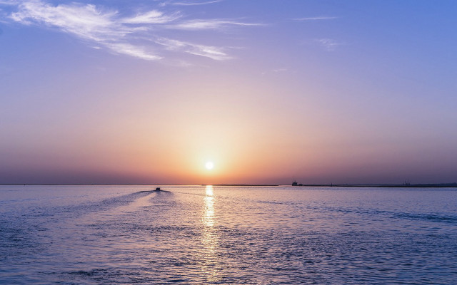 Boat sunset distant mountains ocean free wallpaper for desktop - medium preview image