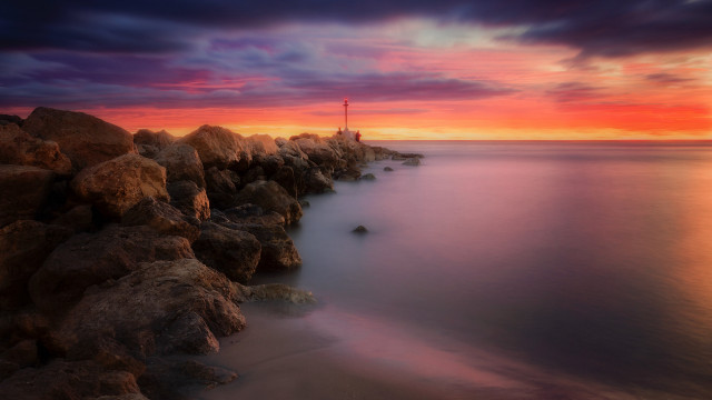 Sunset rocky beach lighthouse water free wallpaper for desktop - medium preview image