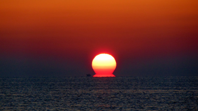 Orange sun over ocean surrealist free wallpaper for desktop - medium preview image