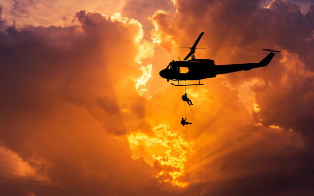 Helicopter lowered by man sunset free wallpaper for desktop - medium preview image