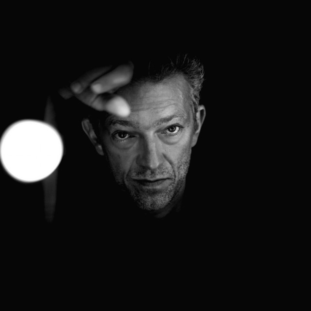 Man looking camera dark light free wallpaper for tablet - medium preview image