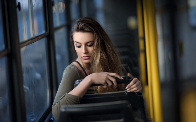Woman sitting bus cellphone suitcase free wallpaper for desktop - medium preview image