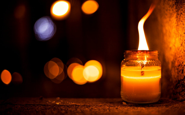 Candle lit jar bokeh dark free wallpaper for desktop - medium preview image
