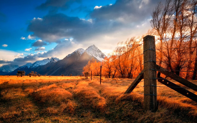 Fence field mountains cloudy sky free wallpaper for desktop - medium preview image