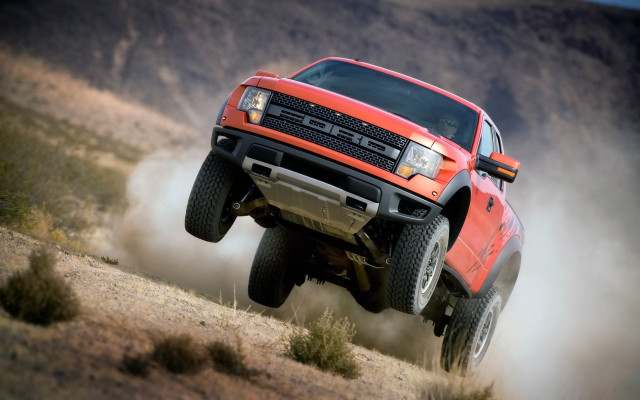 Red truck jumping hill dust free wallpaper for desktop - medium preview image