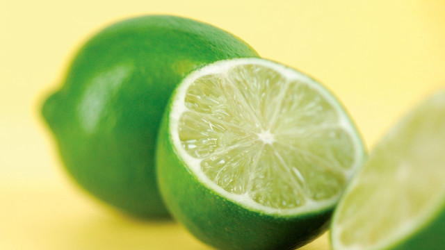 Lime halved on yellow surface free wallpaper for desktop - medium preview image