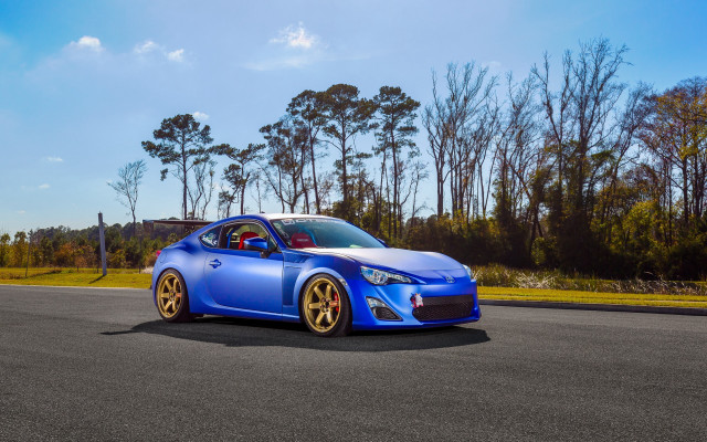 Blue car road trees grass free wallpaper for desktop - medium preview image