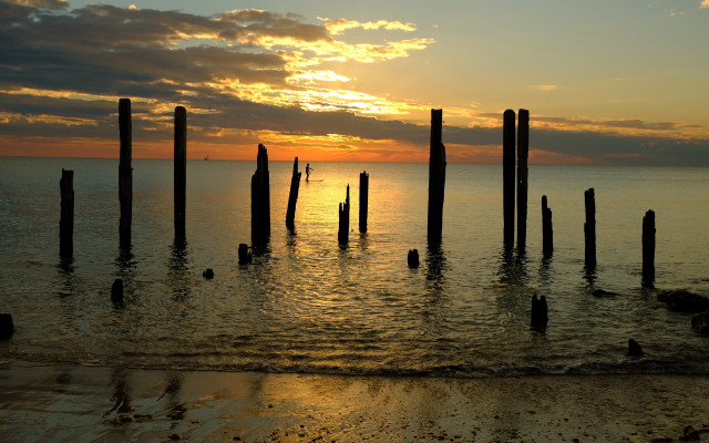 Sunset ocean poles shore people free wallpaper for desktop - medium preview image