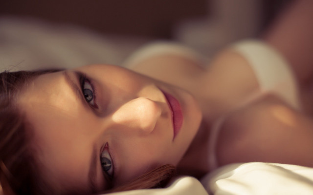 Woman laying bed blurry photorealistic free wallpaper for desktop - medium preview image