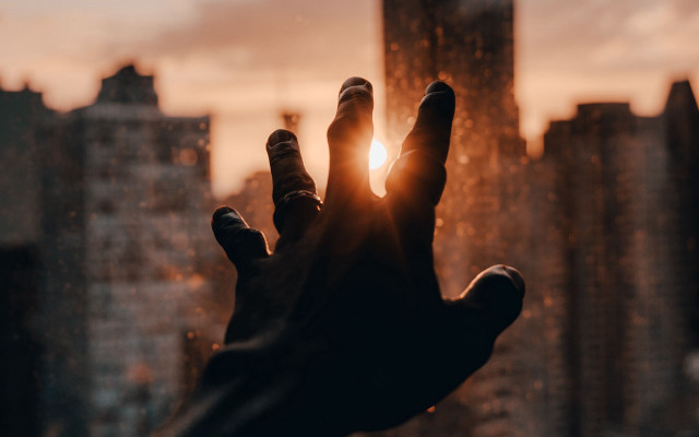 Hand reaching sun city blurry free wallpaper for desktop - medium preview image