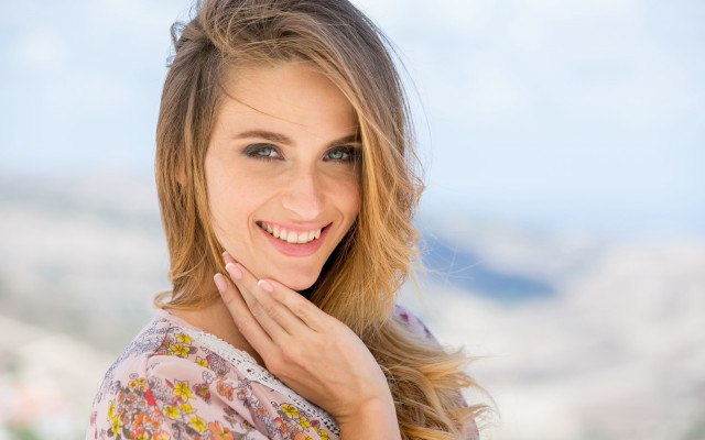 Woman smiling mountain blue sky free wallpaper for desktop - medium preview image